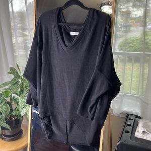 Black hi-low lightweight top with dropped shoulder and batwing sleeves.